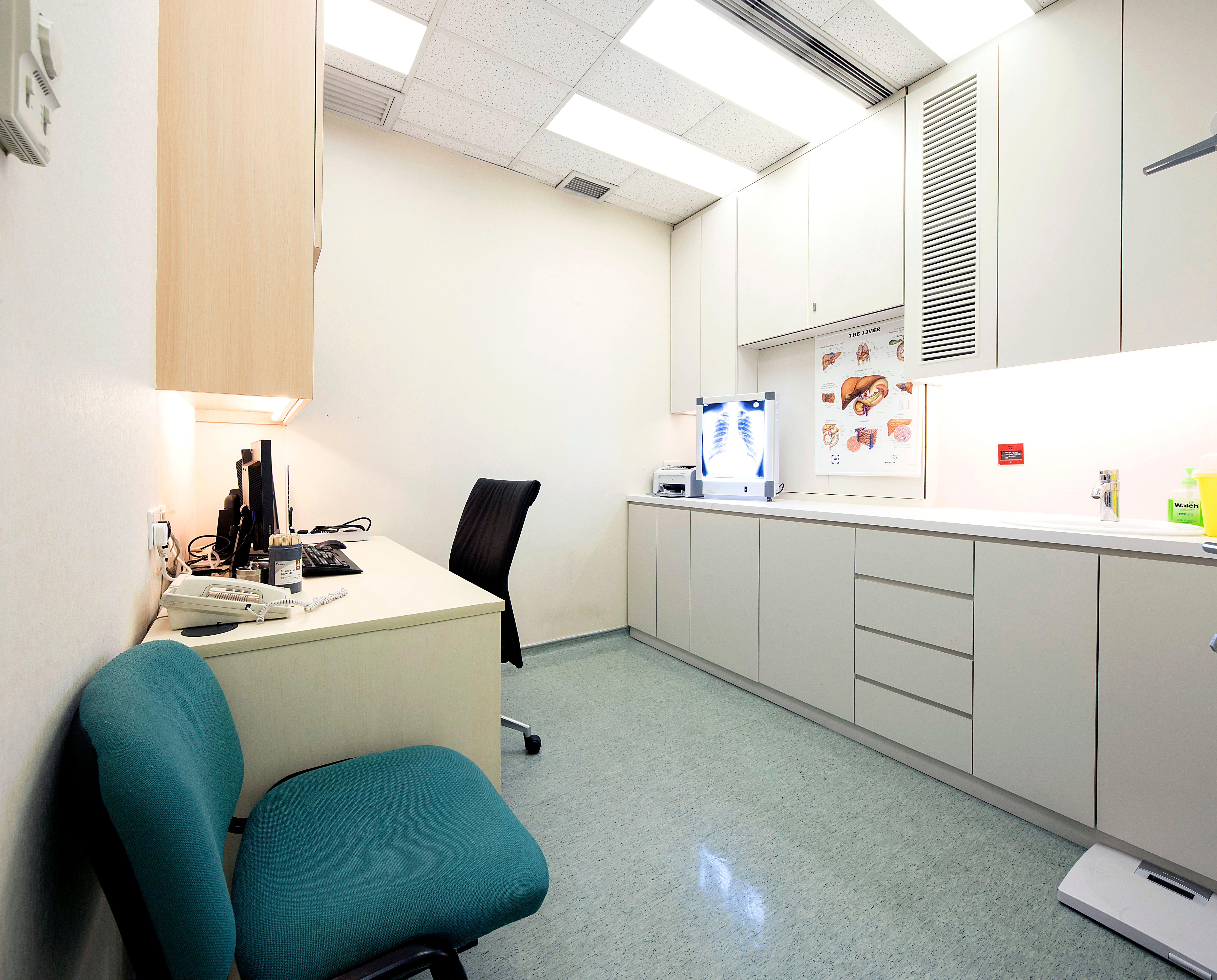 Consultation room with desk, cabinets, chest X-ray