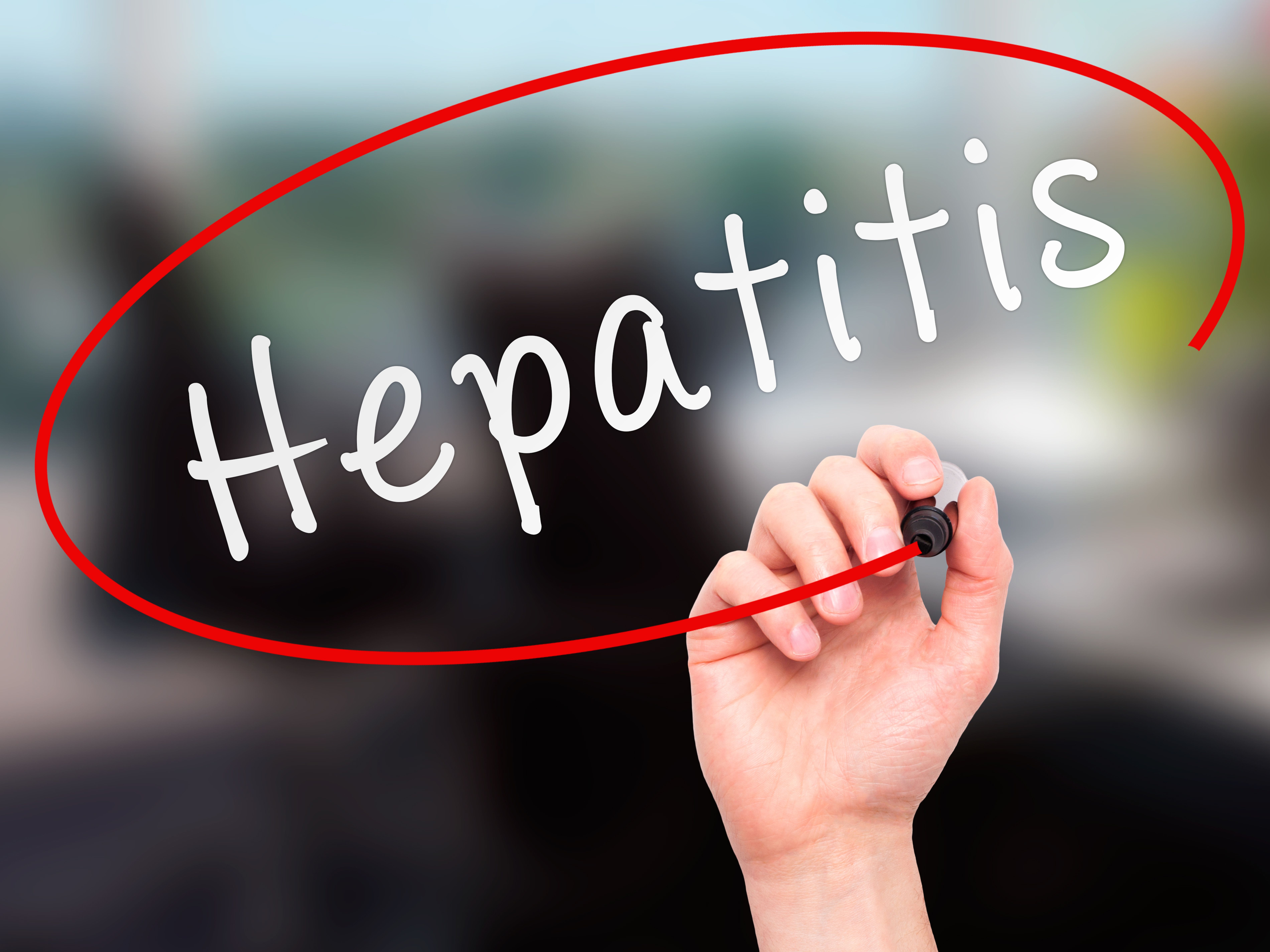 Hand writing Hepatitis with a red circle around it