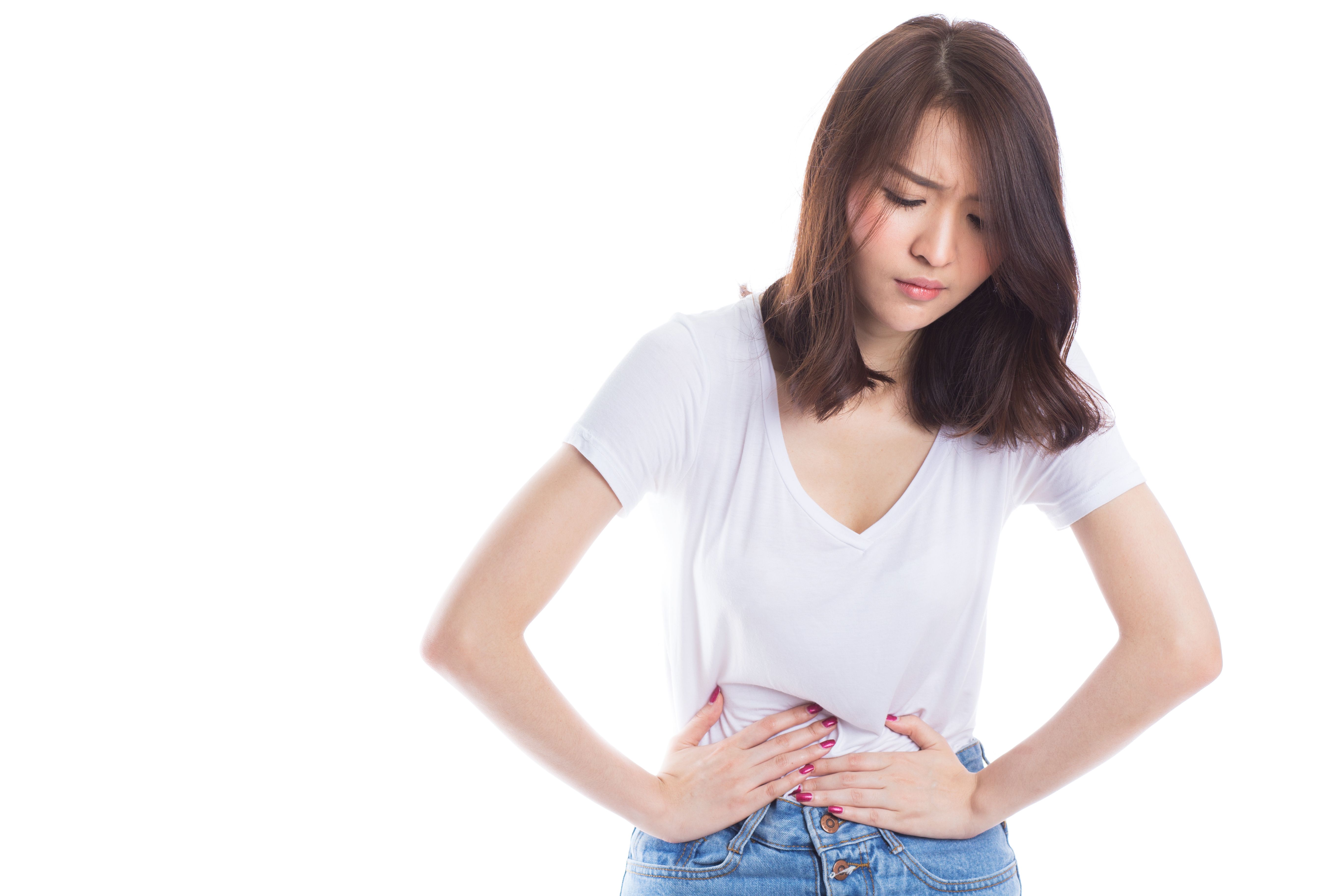 Woman with both hands pressed on abdomen in pain