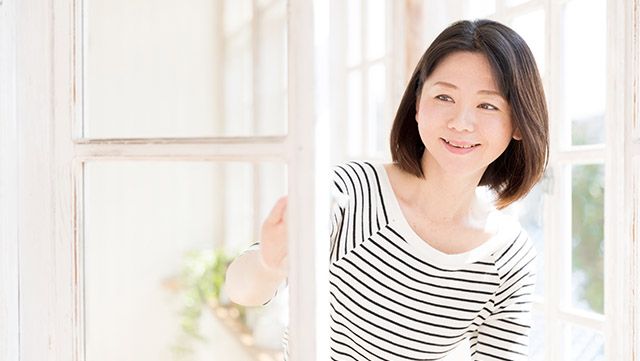 Woman in a striped top looking out the window