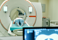 A patient lying down in diagnostic imaging equipment