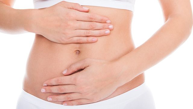 Woman with hands placed on her abdomen