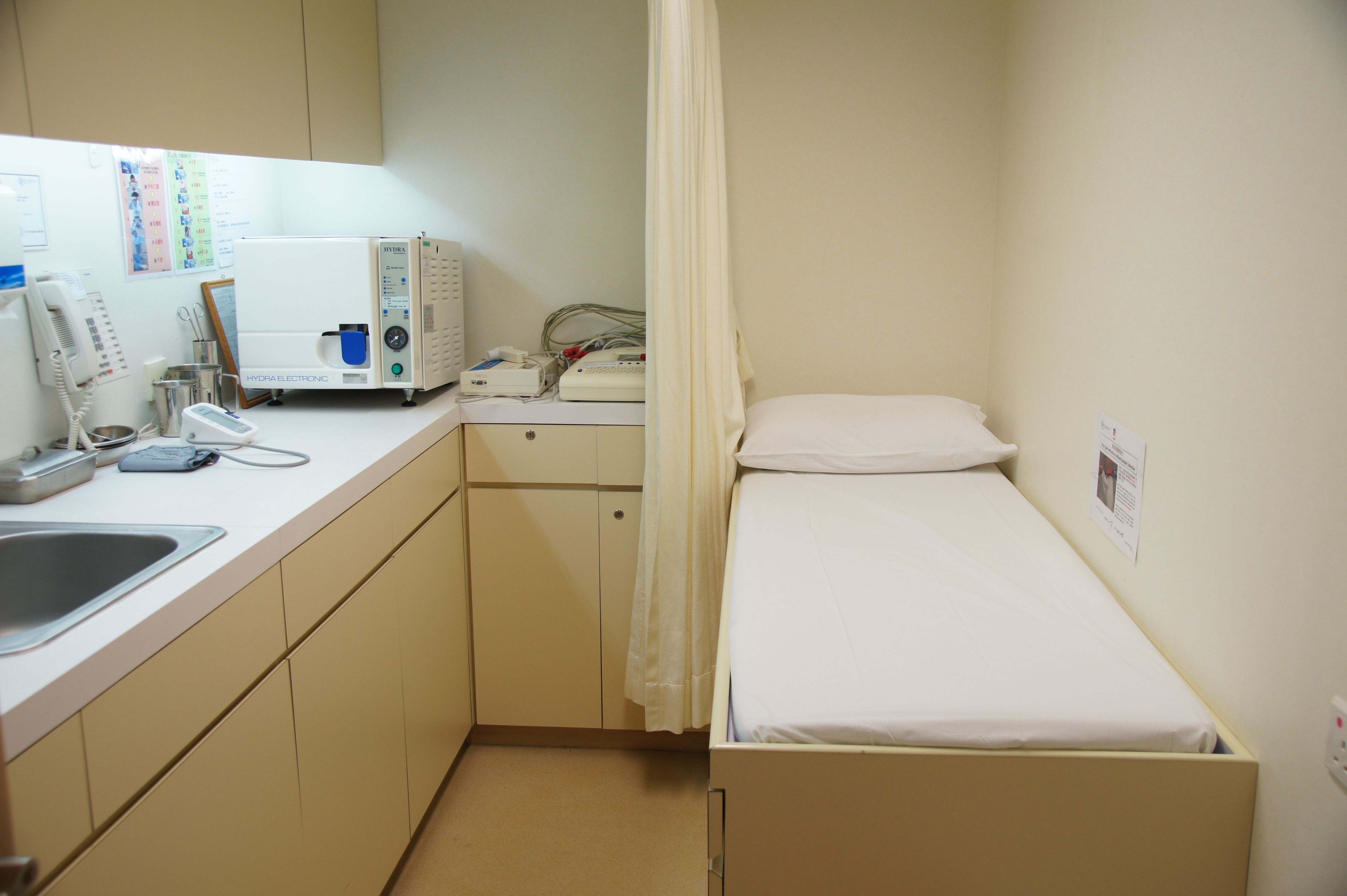 Examination room with patient bed and sink