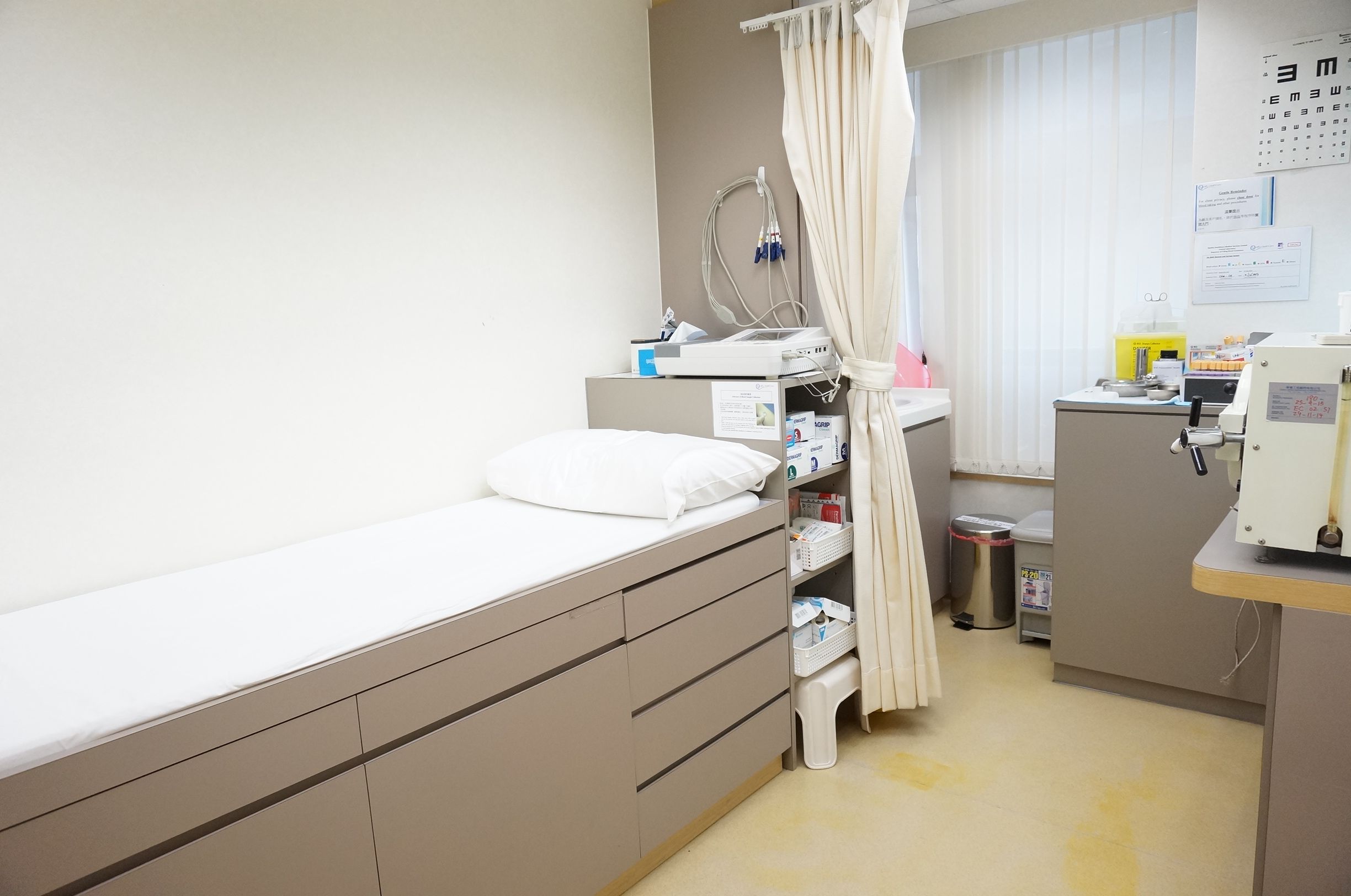 Consultation room with patient bed and medical equipment