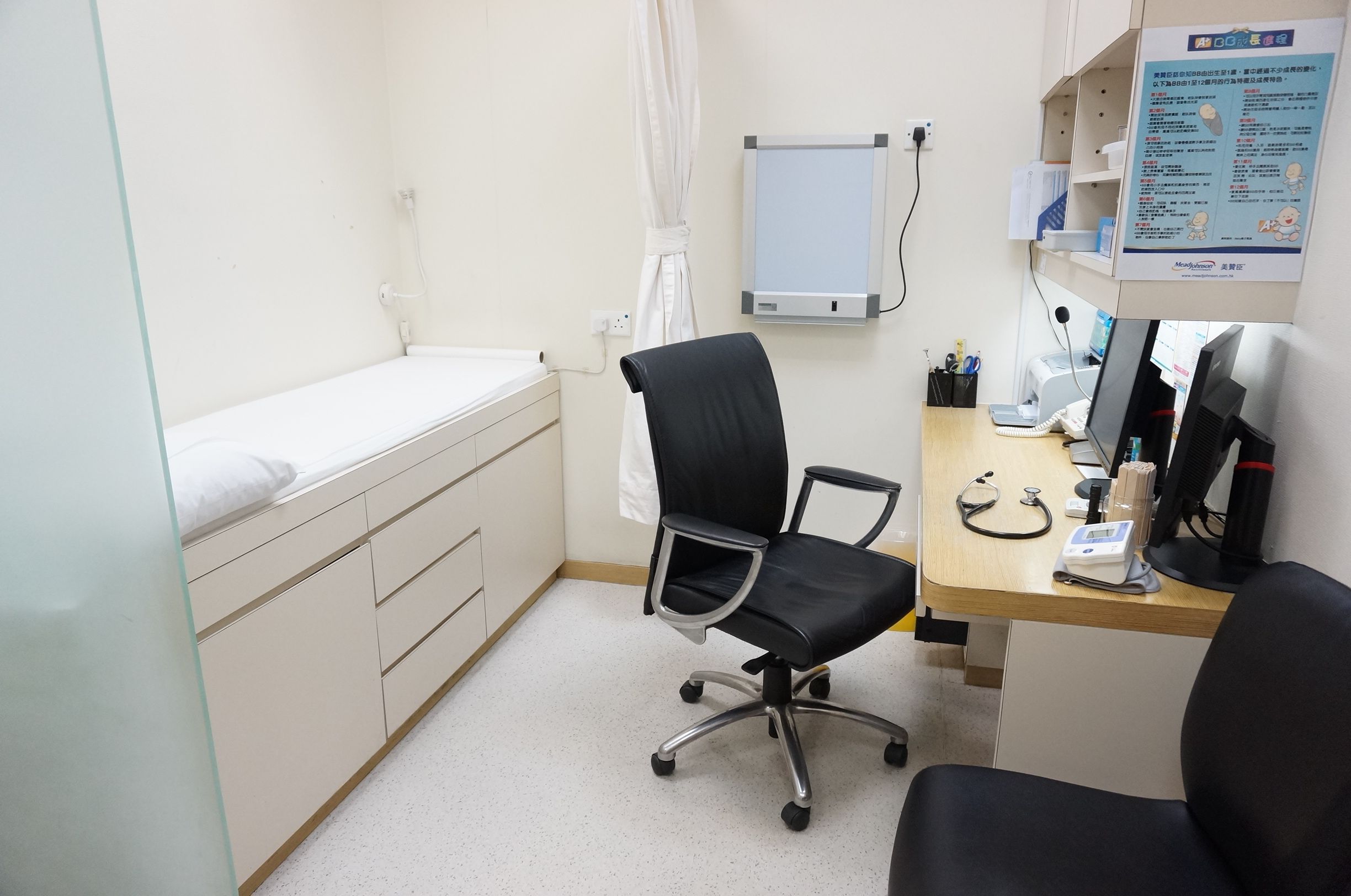 Consultation room with patient bed, desk