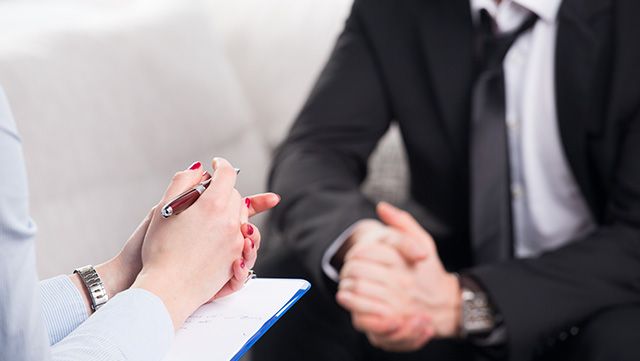 Close-up of psychiatrist's hands and chart