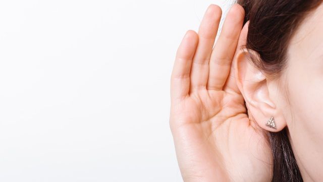 Close-up of hand cupped to ear