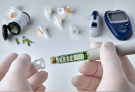 Close-up of hands holding a device used for taking blood samples