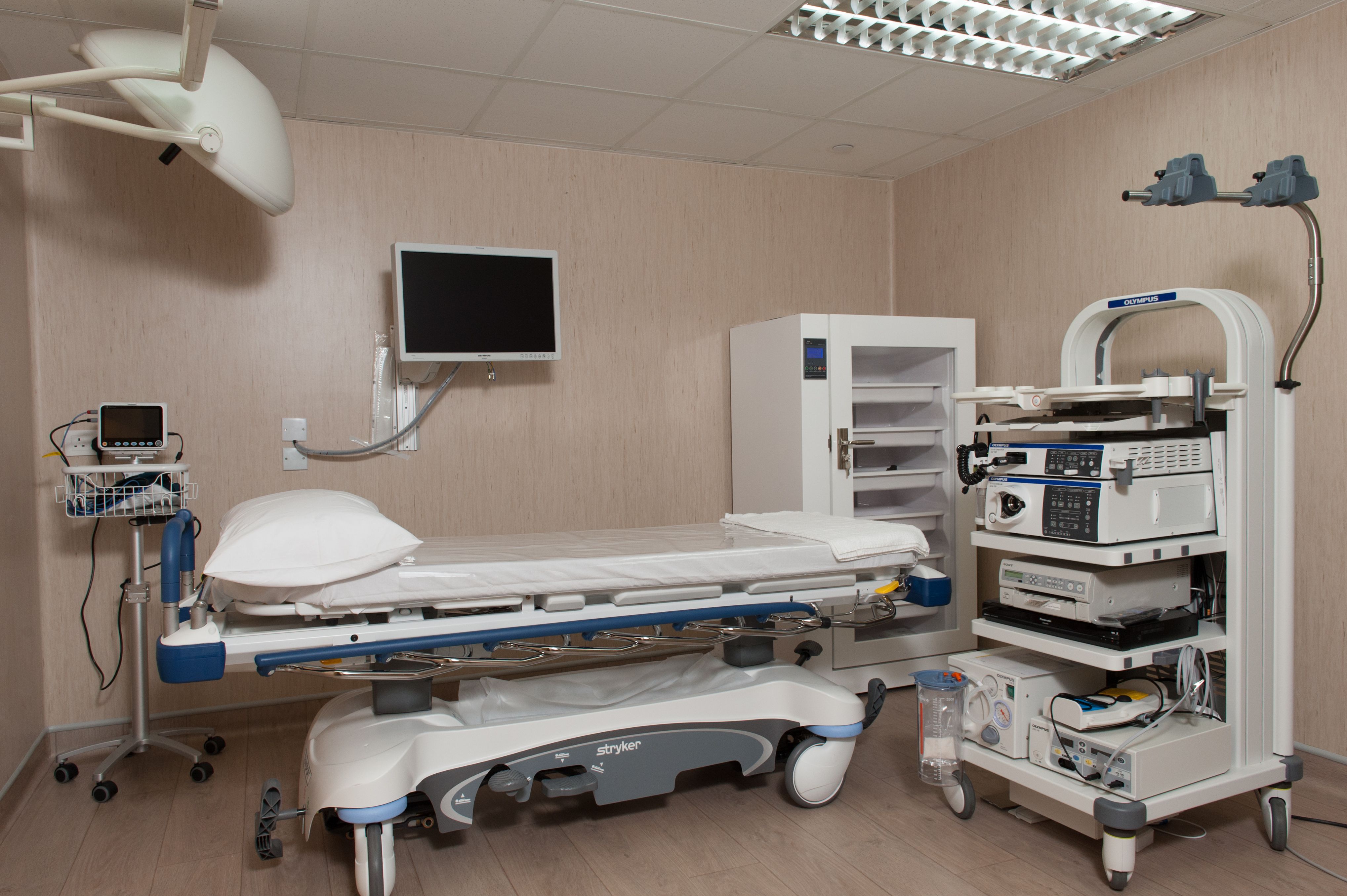 Examination room with patient bed and medical equipment