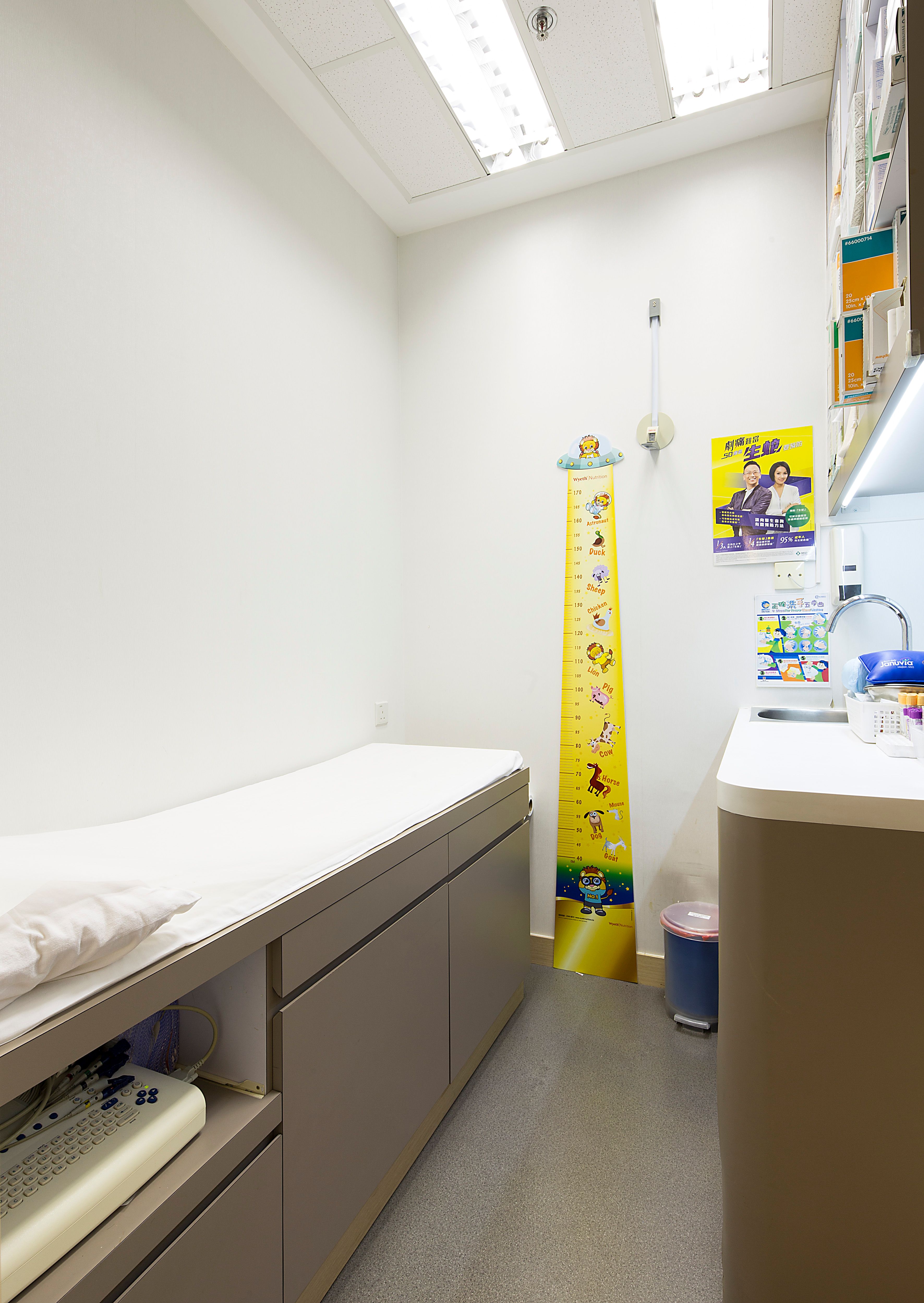 Examination room with patient bed and wall growth chart