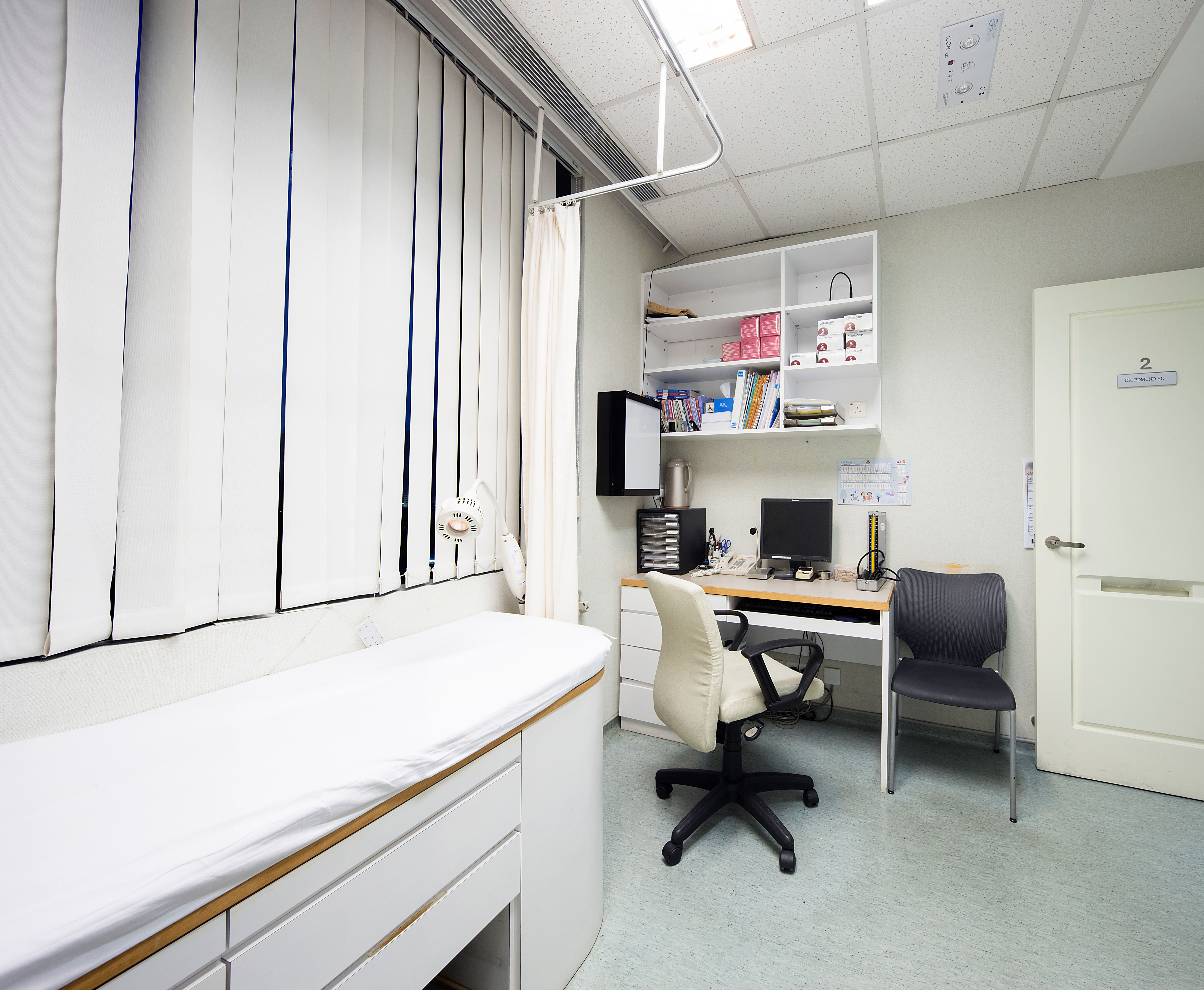 Consultation room with patient bed and desk
