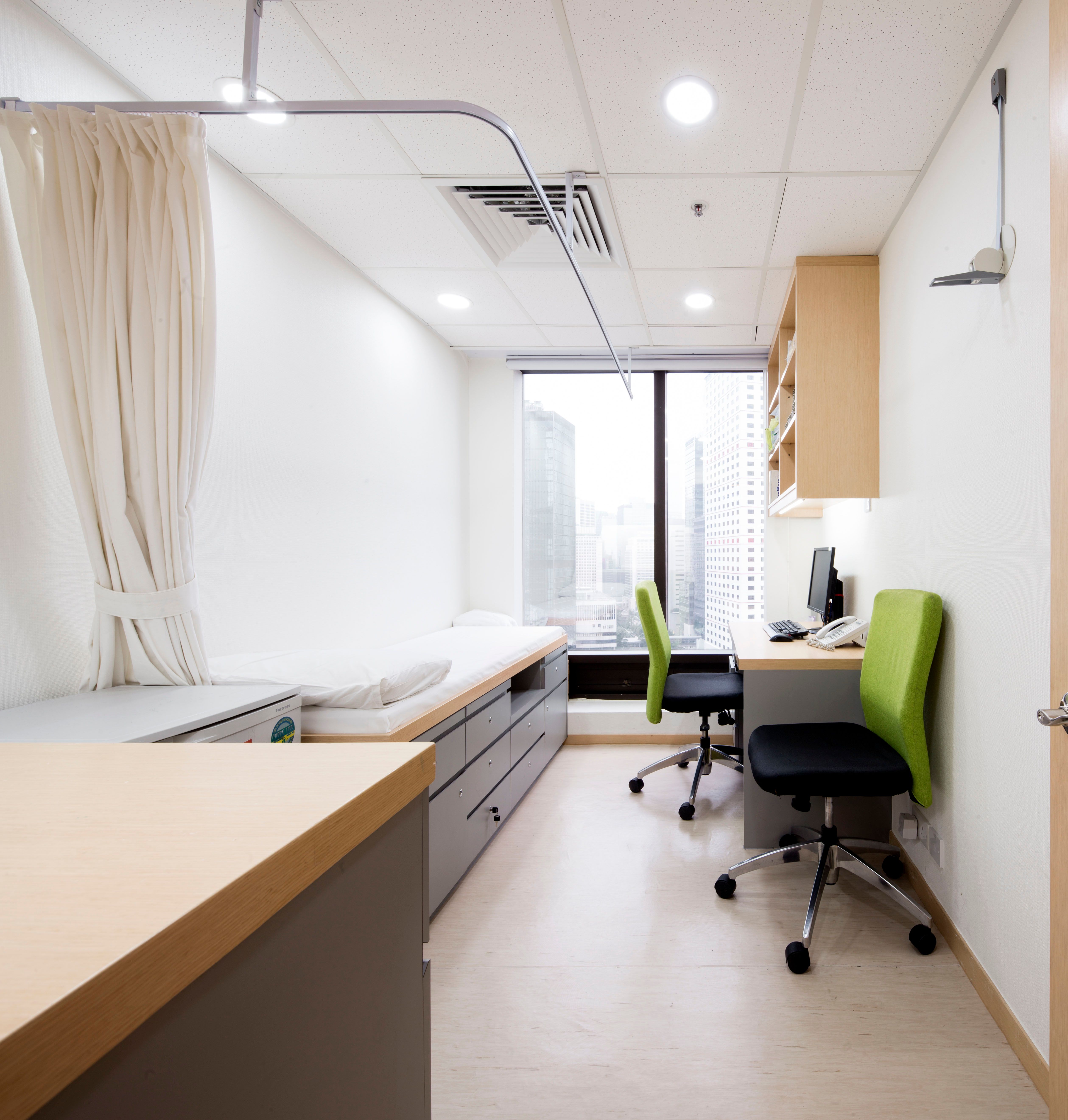 Consultation room with patient bed and desk