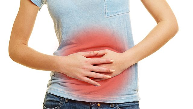 Woman with both hands on painful stomach