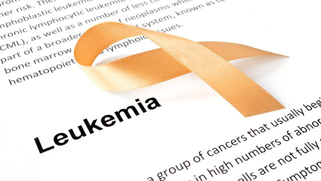 Close-up of paper with the word Leukemia and gold ribbon
