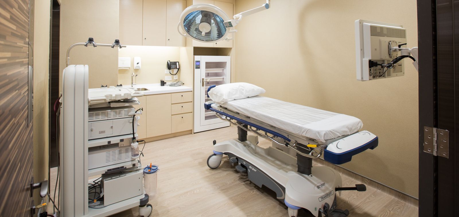Examination room with patient bed and other medical equipment