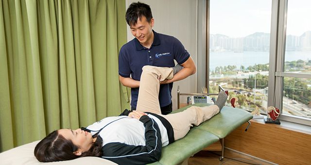 Physiotherapist manipulating a patient's leg