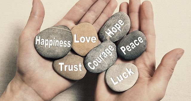 Hand holding stones with love words image which is a decorative image