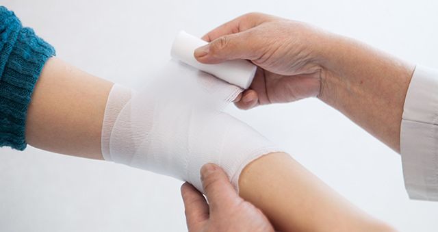 Arm being wrapped in a bandage
