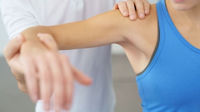 a Physiotherapist massaging patient